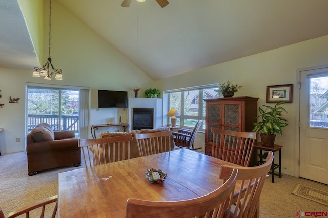 301 Talisman Dr Unit 4319, Pagosa Springs, CO 81147 - dining area with light carpet, high vaulted ceiling, a glass covered fireplace, and healthy amount of natural light