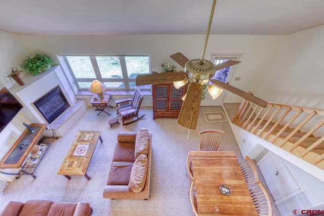 301 Talisman Dr Unit 4319, Pagosa Springs, CO 81147 - carpeted living room with a glass covered fireplace, stairs, and a ceiling fan