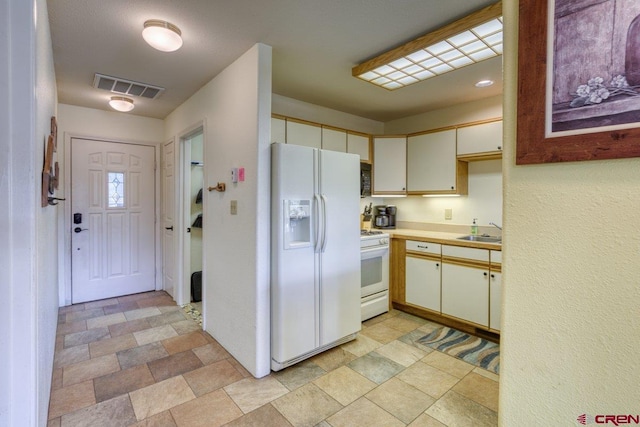 301 Talisman Dr Unit 4319, Pagosa Springs, CO 81147 - kitchen with white appliances, a sink, light countertops, and stone finish floors