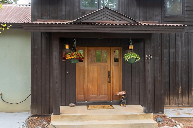 view of exterior entry with metal roof