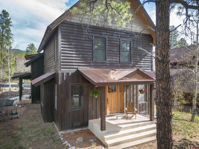 view of front of home featuring board and batten siding and metal roof
