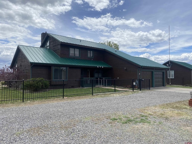16303 6760th Rd, Montrose, CO 81401 - chalet / cabin with driveway, an attached garage, a chimney, and a fenced front yard