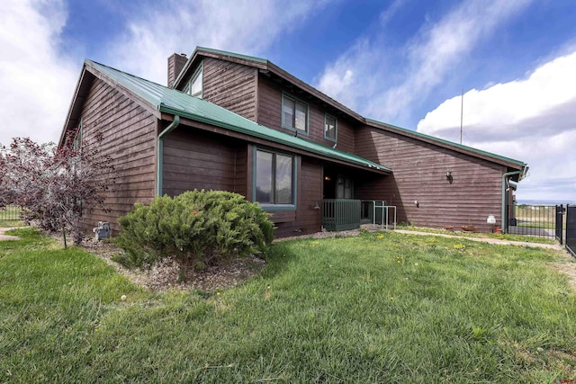 16303 6760th Rd, Montrose, CO 81401 - back of property with a chimney and central AC