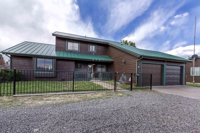 16303 6760th Rd, Montrose, CO 81401 - view of front facade featuring driveway, a fenced front yard, a garage, metal roof, and a standing seam roof