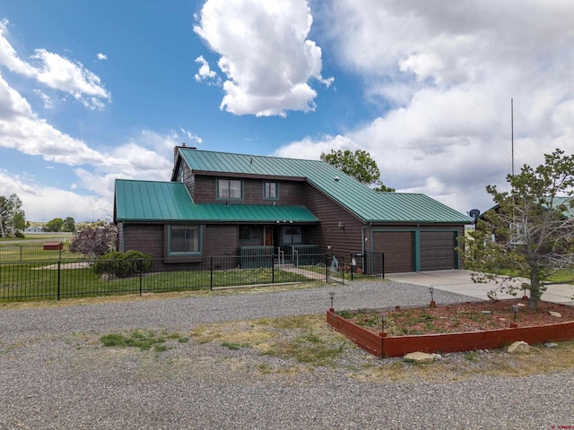 16303 6760th Rd, Montrose, CO 81401 - rustic home featuring driveway, a garage, metal roof, and a vegetable garden