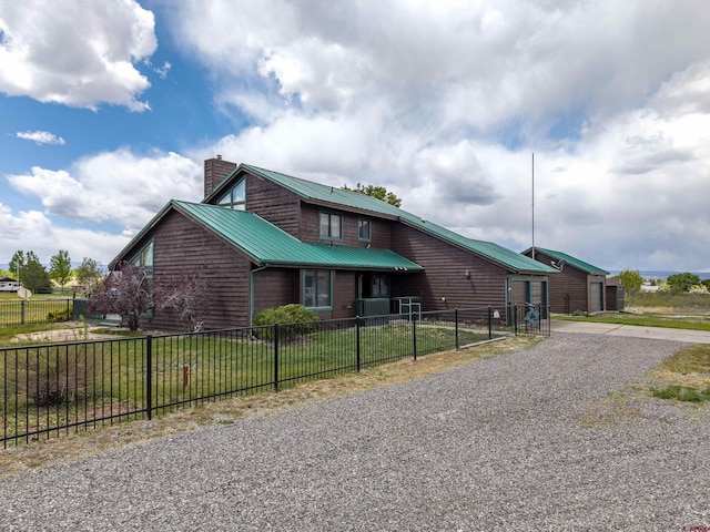 16303 6760th Rd, Montrose, CO 81401 - view of front of home featuring a chimney, metal roof, and driveway