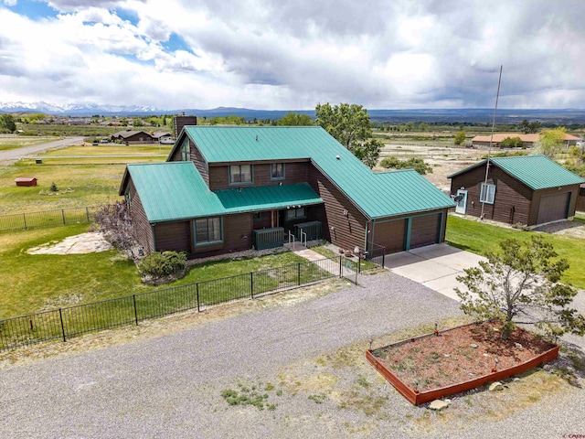 16303 6760th Rd, Montrose, CO 81401 - view of front of property featuring concrete driveway, metal roof, central air condition unit, an attached garage, and a garden