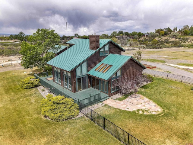 16303 6760th Rd, Montrose, CO 81401 - rear view of house with a chimney, a standing seam roof, metal roof, and a sunroom