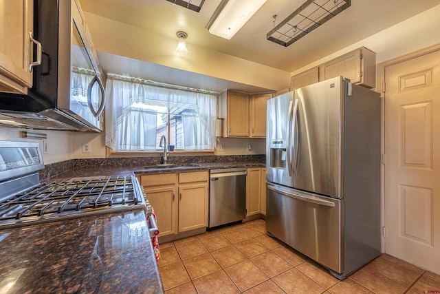 16303 6760th Rd, Montrose, CO 81401 - kitchen with appliances with stainless steel finishes, a sink, light tile patterned floors, and dark stone countertops