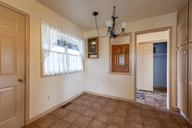 16303 6760th Rd, Montrose, CO 81401 - unfurnished dining area featuring a chandelier, baseboards, and tile patterned floors