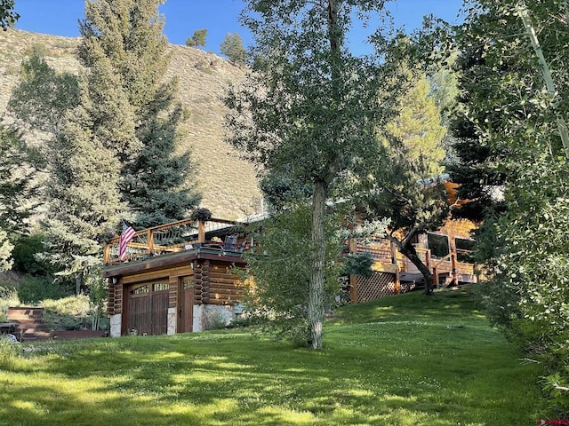 209 Deer Path Ln, Almont, CO 81230 - view of green lawn with a deck and a garage