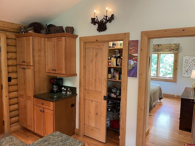 209 Deer Path Ln, Almont, CO 81230 - kitchen with light wood-type flooring, lofted ceiling, and brown cabinets