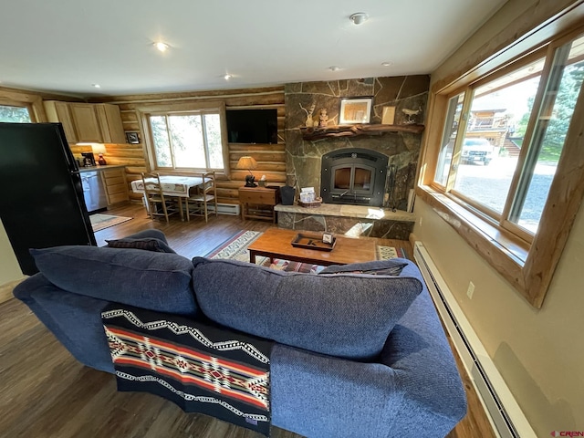 209 Deer Path Ln, Almont, CO 81230 - living room featuring wood finished floors, log walls, a baseboard radiator, and a fireplace