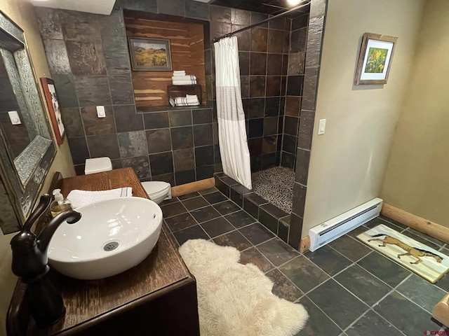 209 Deer Path Ln, Almont, CO 81230 - bathroom with a baseboard heating unit, tiled shower, toilet, and baseboards