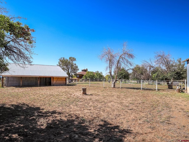 14120 Rd 26, Dolores, CO 81323 - view of yard featuring an outbuilding, an exterior structure, a pole building, a view of countryside, and fence