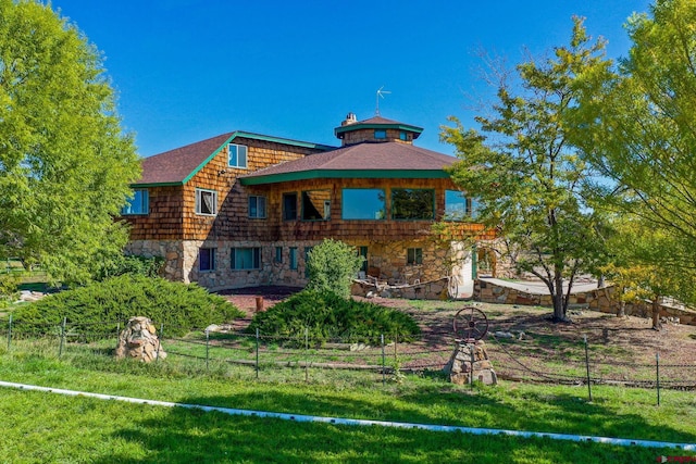 14120 Rd 26, Dolores, CO 81323 - rear view of house with stone siding, fence, and a gazebo