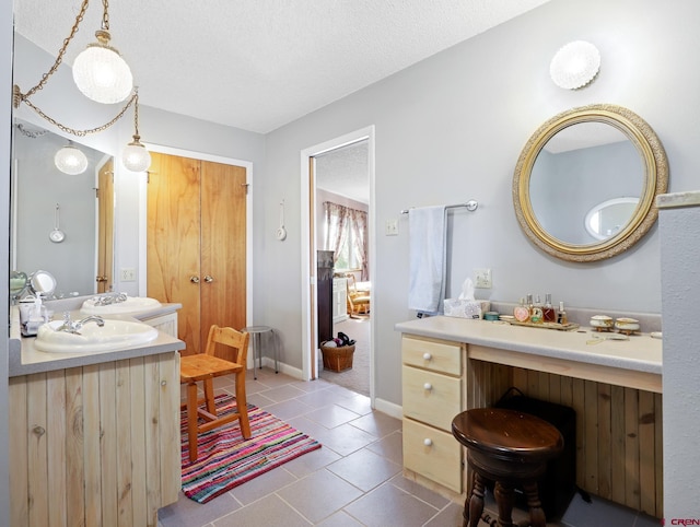 14120 Rd 26, Dolores, CO 81323 - bathroom with tile patterned floors, vanity, a textured ceiling, and baseboards
