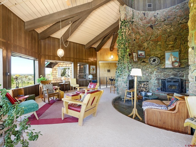 14120 Rd 26, Dolores, CO 81323 - living room with carpet flooring, a wood stove, high vaulted ceiling, wooden walls, and beam ceiling