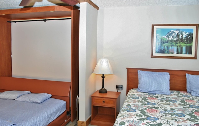 bedroom featuring a textured ceiling and a ceiling fan