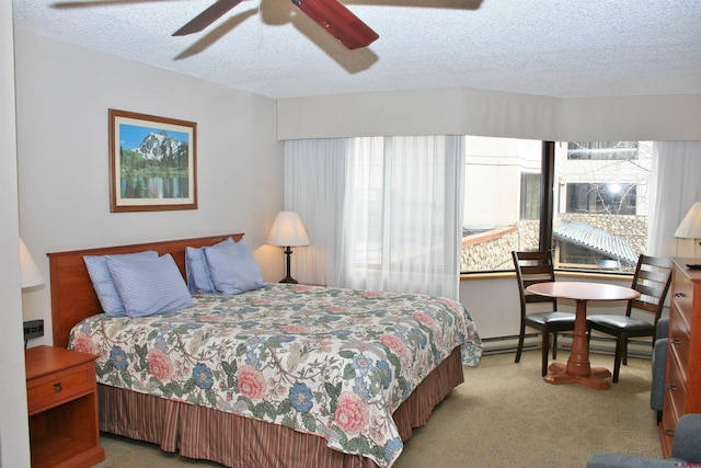 bedroom featuring carpet, a textured ceiling, and ceiling fan