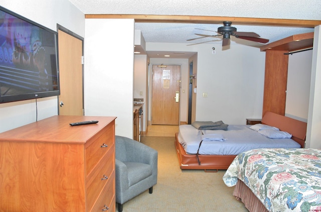 bedroom featuring light carpet and a textured ceiling