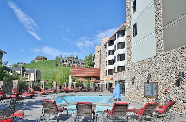 community pool featuring a patio area