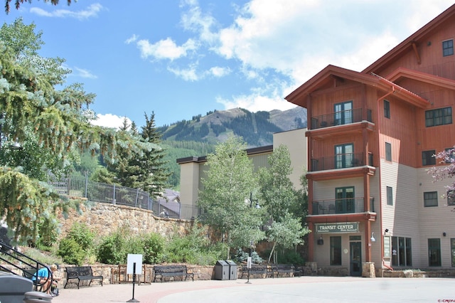 view of property featuring a mountain view and fence