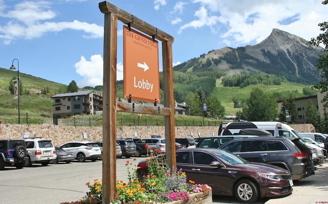 exterior view of a mountain view, parking, and fence