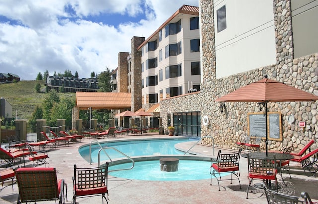 community pool featuring a patio area