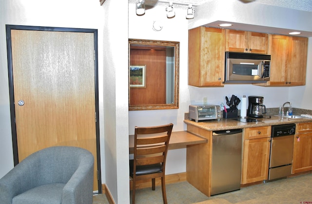 kitchen with stainless steel microwave, a sink, dishwasher, and light stone counters