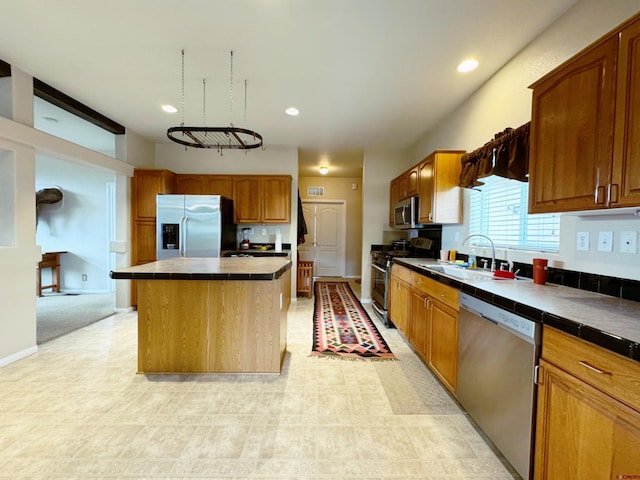360 Forest Hill Rd, Ridgway, CO 81432 - kitchen featuring appliances with stainless steel finishes, tile counters, a sink, a kitchen island, and recessed lighting