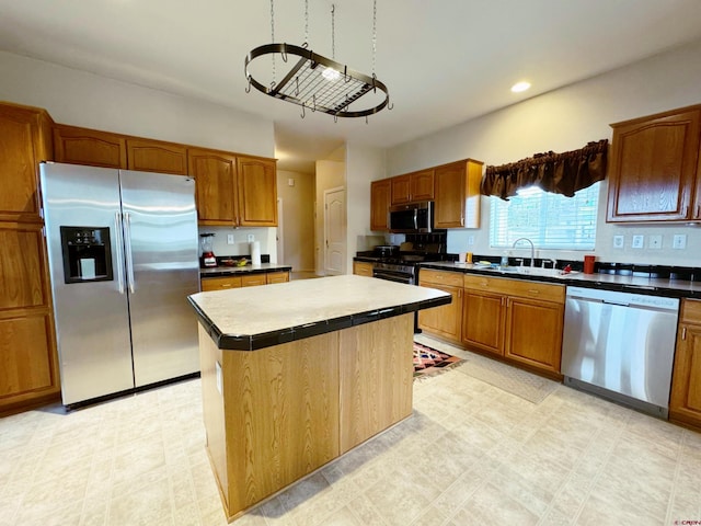 360 Forest Hill Rd, Ridgway, CO 81432 - kitchen featuring stainless steel appliances, a sink, brown cabinetry, a kitchen island, and recessed lighting