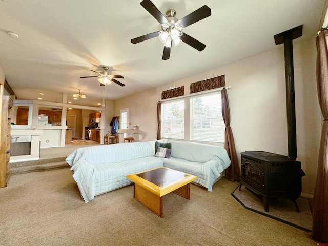 360 Forest Hill Rd, Ridgway, CO 81432 - carpeted bedroom featuring a wood stove and a ceiling fan