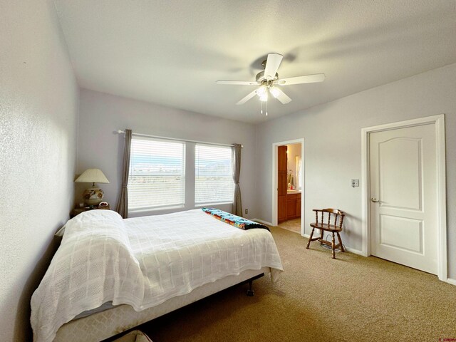360 Forest Hill Rd, Ridgway, CO 81432 - bedroom featuring light carpet, ceiling fan, baseboards, and connected bathroom