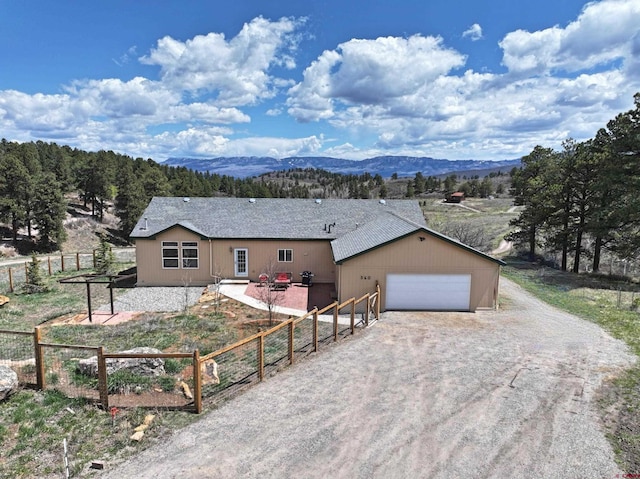 360 Forest Hill Rd, Ridgway, CO 81432 - single story home with a mountain view, fence, dirt driveway, and an attached garage
