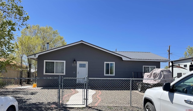 1510 W Sixth St, Alamosa, CO 81101 - view of front of home featuring a gate, a fenced front yard, and metal roof