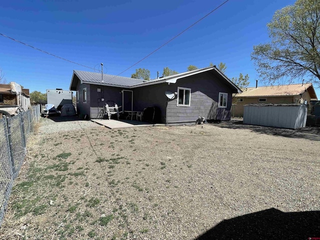 1510 W Sixth St, Alamosa, CO 81101 - back of house with fence, a patio, and metal roof