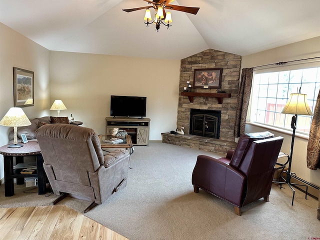 living area featuring vaulted ceiling, ceiling fan, a fireplace, and carpet floors