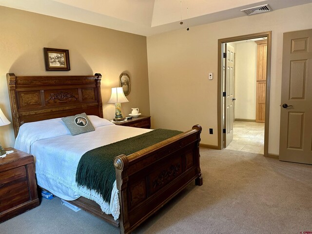 bedroom featuring light carpet and baseboards