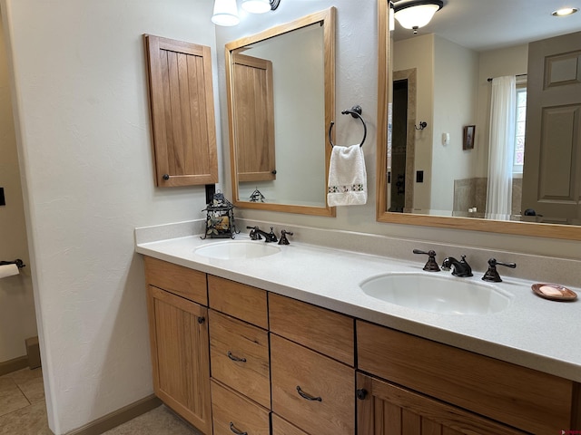 bathroom featuring double vanity and baseboards
