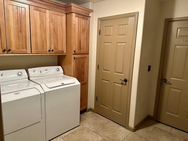 washroom with independent washer and dryer, cabinet space, light tile patterned floors, and baseboards