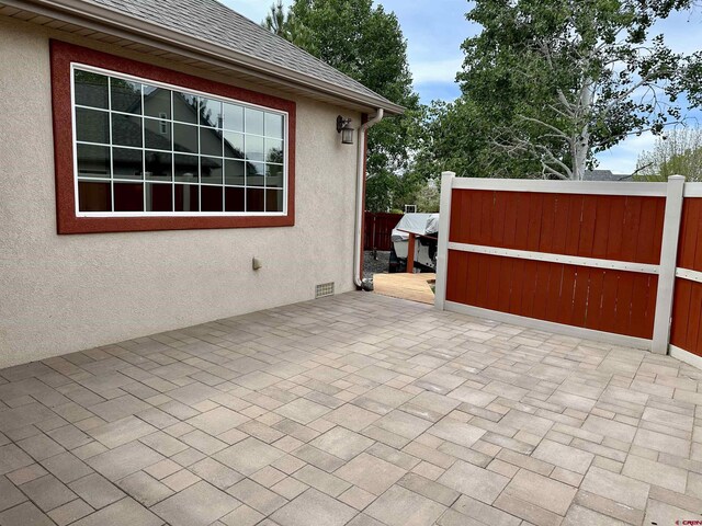 view of patio featuring fence