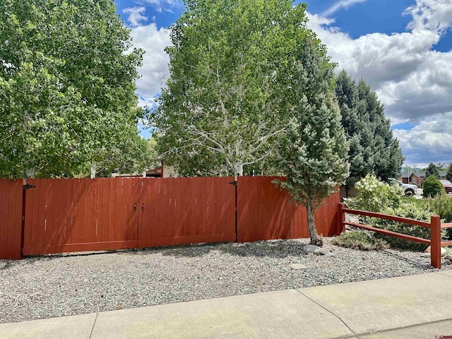 view of yard with fence and a gate
