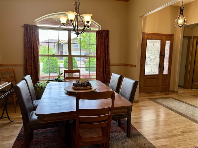 dining space featuring a chandelier and light wood-style flooring