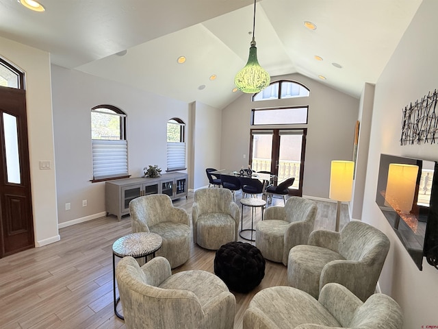 3416 Main Ave Unit 201, Durango, CO 81301 - living room featuring healthy amount of natural light, light wood-style flooring, vaulted ceiling, and baseboards