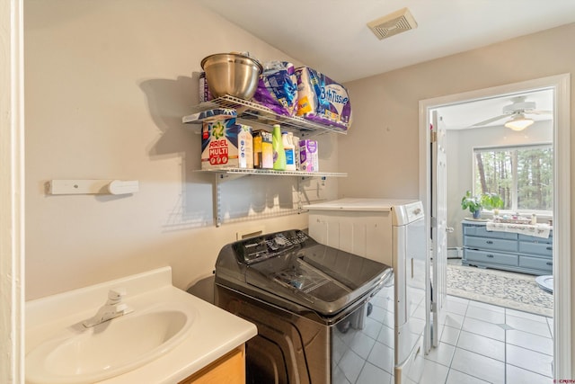 washroom with washer and clothes dryer and light tile patterned flooring