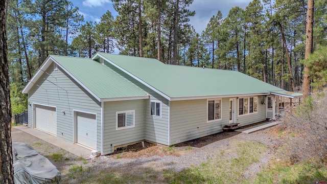 view of home's exterior featuring metal roof and a garage