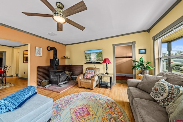 1257 Snowden St, Silverton, CO 81433 - living room with a ceiling fan, wood finished floors, crown molding, baseboards, and a wood stove