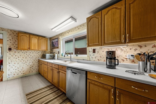 1257 Snowden St, Silverton, CO 81433 - kitchen with appliances with stainless steel finishes, wallpapered walls, a sink, light countertops, and brown cabinetry