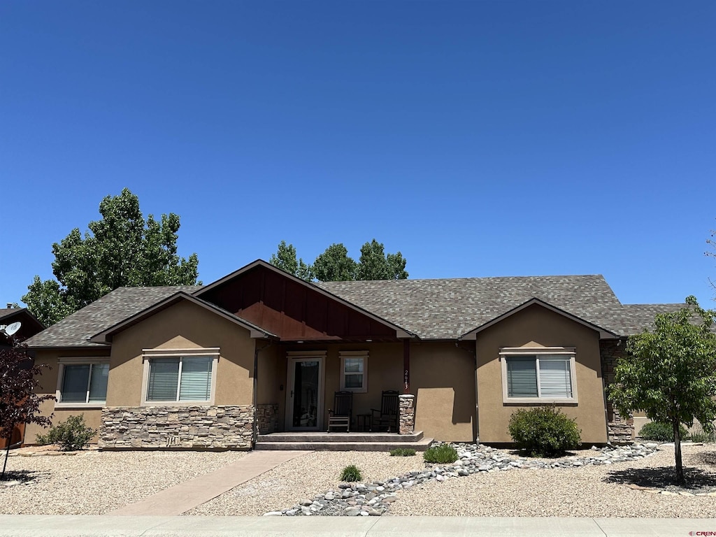 2643 Peyton Dr, Montrose, CO 81401 - ranch-style house featuring stucco siding, stone siding, a porch, and roof with shingles